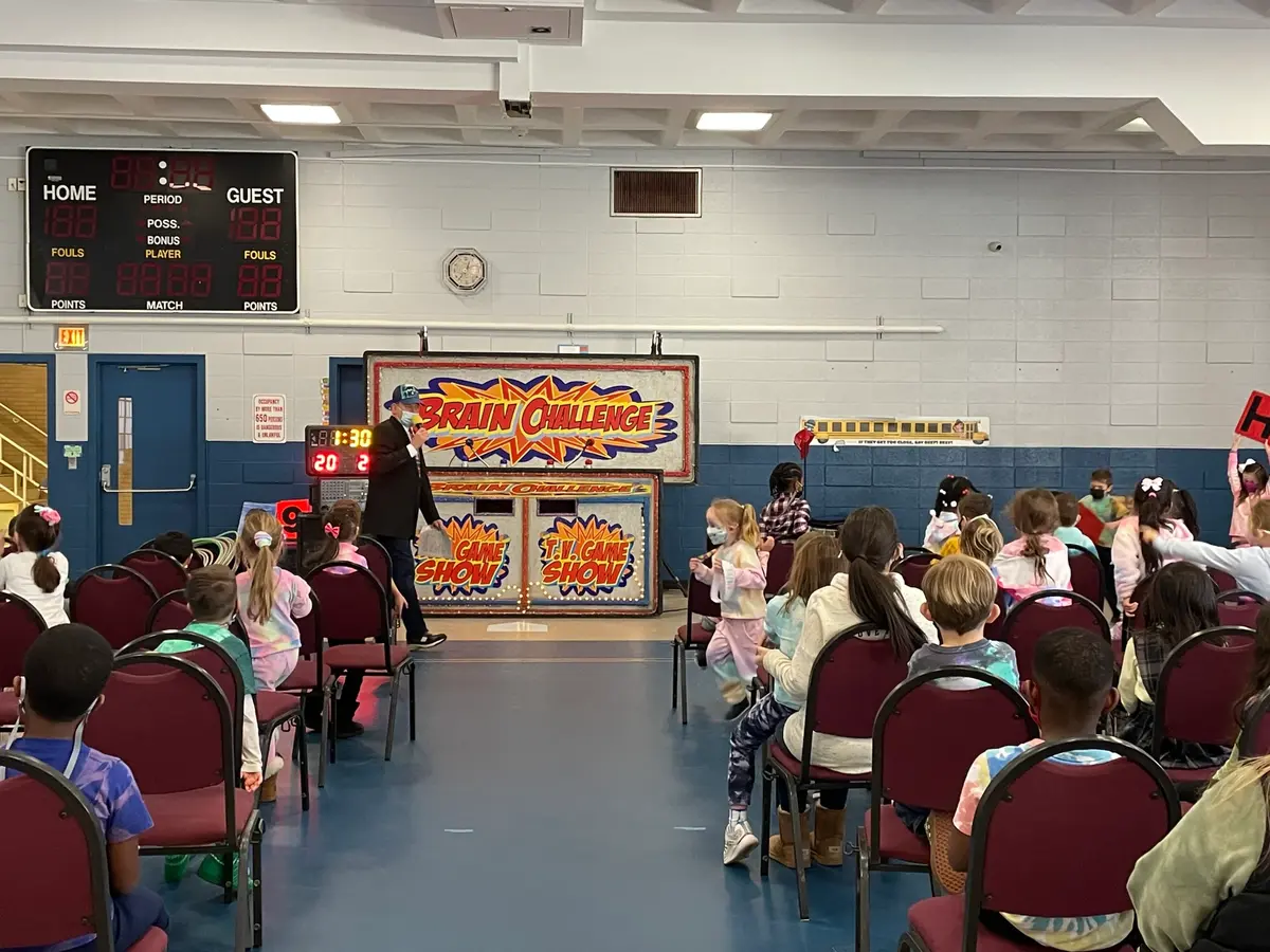 school assembly kids gathered for entertainment from hollyrock