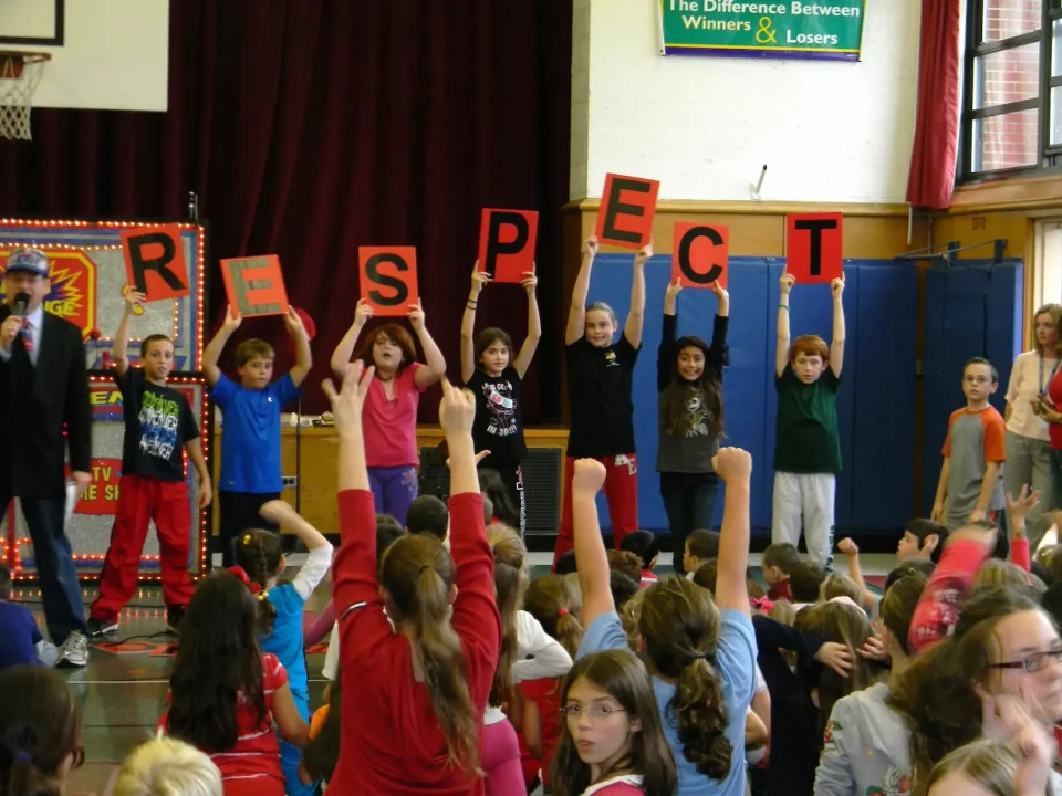 anti bullying assembly - kids holding letters spelling RESPECT